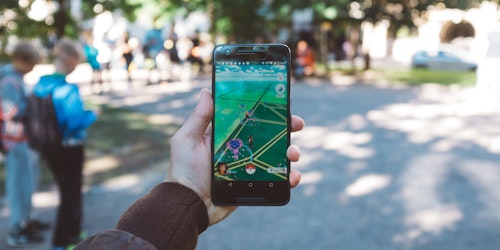 A phone playing Pokemon Go in a park