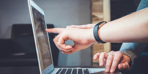 People point at a laptop screen 