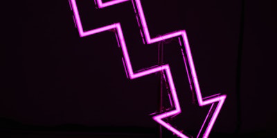 A neon arrow pointing downward
