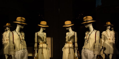 A number of mannequins, wearing different outfits