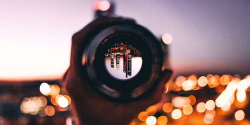 A city, appearing upside down through a lens