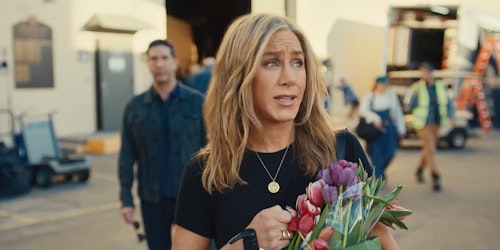 Jennifer Aniston walks away from David Schwimmer, carrying an Uber Eats bag full of flowers