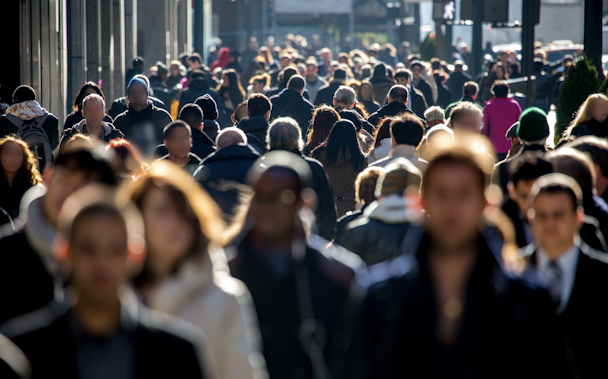 People walking down a busy city street